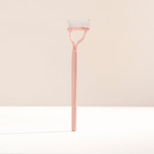 Lash comb on a beige background 