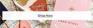 shop now banner with notebooks, pen and map