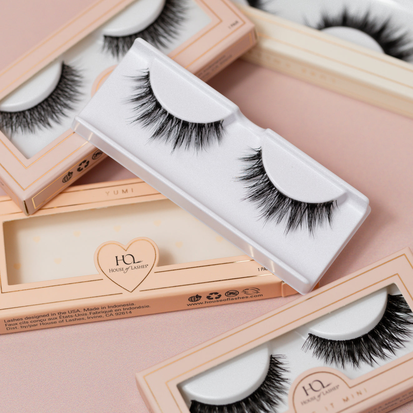 A mix of lashes laid onto a pink background. 