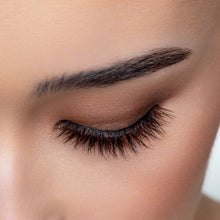 A top view of a woman's eye wearing Americano False Eyelashes.