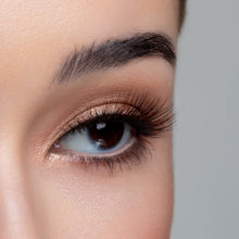 A side eye view of a woman's eye wearing Americano False Eyelashes.