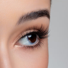 A side eye view of a woman's eye wearing Emiko false eyelashes.