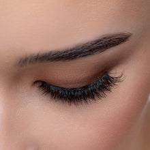 A top view of a woman's eye wearing Kitty Cat false eyelashes.