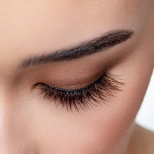 A top view of a woman's eye wearing Latte false eyelashes.