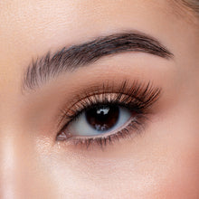 A front view of a woman's eye wearing Latte.