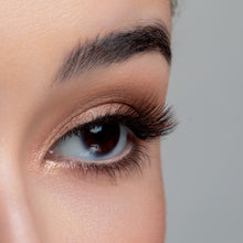 A side view of a woman's eye wearing Macchiato false eyelashes.