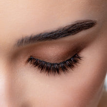 A top view of a woman's eye wearing Mocha false eyelashes.