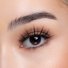 A front view of a woman's eye wearing Yumi false eyelashes.