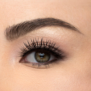A front view of a woman's eye wearing Boudoir false eyelashes.
