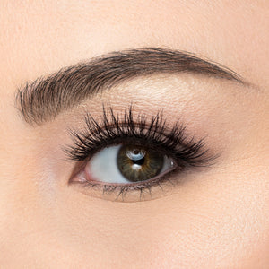 A front view of a woman's eye wearing Iconic Lite false eyelashes.