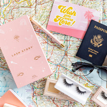 Lash Story Wanderlust on a map with a passport, sunglasses, and Allura Lite false eyelashes.