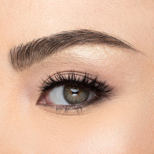 A front view of a woman's eye wearing Iconic Mini false eyelashes.