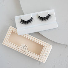 Midnight Luxe false eyelashes in packaging on a textured background.